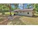 Inviting home backyard featuring outdoor dining and seating, designed for serene moments at 4180 W Anthony Rd, Ocala, FL 34475