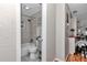Well-lit bathroom featuring a shower-tub combo, decorative tiles, and a stylish vanity at 4180 W Anthony Rd, Ocala, FL 34475