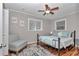 Cozy bedroom features a bed, chair, and windows that provide natural light at 4180 W Anthony Rd, Ocala, FL 34475