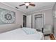 A bright bedroom with hardwood floors, featuring a bed with soft bedding and a patterned chair at 4180 W Anthony Rd, Ocala, FL 34475