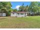 Picture-perfect single-story house with a covered patio, offering comfortable outdoor living at 4180 W Anthony Rd, Ocala, FL 34475