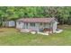 Aerial shot of a single-story home with green lawn, storage shed and covered porch at 4180 W Anthony Rd, Ocala, FL 34475