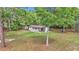 Charming single-story home with a sprawling lawn and mature trees, providing a serene and inviting atmosphere at 4180 W Anthony Rd, Ocala, FL 34475