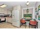 Bright kitchen featuring white appliances, tile floor and a spacious eating nook at 4180 W Anthony Rd, Ocala, FL 34475