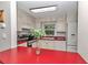 Bright kitchen with white cabinetry, red countertops and stainless steel oven at 4180 W Anthony Rd, Ocala, FL 34475