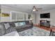Cozy living room featuring a comfortable couch, large window and ceiling fan at 4180 W Anthony Rd, Ocala, FL 34475