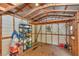 Functional storage area with wood frame, metal roof, shelving, and wall-mounted air conditioning unit at 4180 W Anthony Rd, Ocala, FL 34475