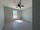 Light-filled bedroom featuring a modern ceiling fan, tile floors, and gray walls at 4424 Sw Carnation Ct, Dunnellon, FL 34431
