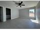 This bedroom features tiled floors, a ceiling fan, and a window overlooking the yard at 4424 Sw Carnation Ct, Dunnellon, FL 34431