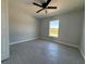Bright bedroom featuring tile floors, neutral gray walls, a ceiling fan, and a view to the outside at 4424 Sw Carnation Ct, Dunnellon, FL 34431