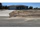 A single-story home with a gray exterior, concrete driveway, a front yard covered with sand, and a blue sky at 4424 Sw Carnation Ct, Dunnellon, FL 34431