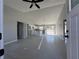 Open concept living space featuring modern gray tile floors, high ceilings, and a spacious kitchen at 4424 Sw Carnation Ct, Dunnellon, FL 34431