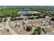 An aerial view of houses nestled in a neighborhood near a school, surrounded by expansive green space and mature trees at 4778 Se 25Th Loop, Ocala, FL 34480