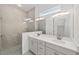 Modern bathroom featuring a double vanity, a framed mirror and a glass-enclosed shower at 4778 Se 25Th Loop, Ocala, FL 34480