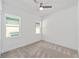 Bright bedroom featuring two windows and a ceiling fan at 4778 Se 25Th Loop, Ocala, FL 34480