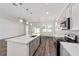 Bright open-concept kitchen with an island, modern appliances, and hardwood floors flowing to the living area at 4778 Se 25Th Loop, Ocala, FL 34480
