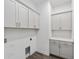 Laundry room with lots of cabinet space and tile flooring at 4778 Se 25Th Loop, Ocala, FL 34480