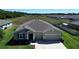 Aerial view of modern home with well-manicured lawn and backyard at 5198 Ne 19Th Pl, Ocala, FL 34470