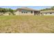 Backyard view of house showing the screened-in patio and lawn at 5198 Ne 19Th Pl, Ocala, FL 34470
