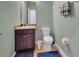 Bathroom with neutral walls, dark wood vanity, and a commode at 5198 Ne 19Th Pl, Ocala, FL 34470