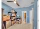 Bedroom with light blue walls, ceiling fan, and doorway to another room at 5198 Ne 19Th Pl, Ocala, FL 34470
