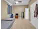 Carpeted bedroom with ceiling fan, closet, TV, and a simple bed at 5198 Ne 19Th Pl, Ocala, FL 34470