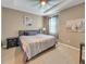 Inviting bedroom with a ceiling fan, a plush bed, and complementary decor at 5198 Ne 19Th Pl, Ocala, FL 34470