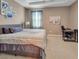 Bright bedroom with a ceiling fan, plush bedding, and a work desk at 5198 Ne 19Th Pl, Ocala, FL 34470
