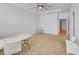 Neutral bedroom featuring a ceiling fan and an open doorway at 5198 Ne 19Th Pl, Ocala, FL 34470