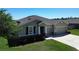 Charming home featuring a well-manicured lawn, a two-car garage, and a welcoming entrance at 5198 Ne 19Th Pl, Ocala, FL 34470