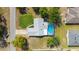 Overhead angle of home featuring screened-in pool, gray roof, and a well-maintained lawn at 5220 Sw 161St Place Rd, Ocala, FL 34473