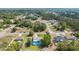 Overhead shot of homes nestled among green trees in a residential area with roads and lawns at 5220 Sw 161St Place Rd, Ocala, FL 34473