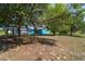 The backyard has a large screened pool enclosure, mature trees and ample space for outdoor activities at 5220 Sw 161St Place Rd, Ocala, FL 34473