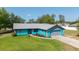 Lovely single-story home displays vibrant blue exterior, gray accents and well-maintained landscaping at 5220 Sw 161St Place Rd, Ocala, FL 34473