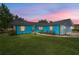 Twilight view of an inviting single-story home with vibrant blue exterior and manicured lawn at 5220 Sw 161St Place Rd, Ocala, FL 34473