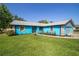 Inviting one-story home boasts a vibrant blue exterior, gray accents, and a meticulously kept lawn at 5220 Sw 161St Place Rd, Ocala, FL 34473