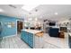 Spacious kitchen with island, stone fireplace, and stainless refrigerator at 5220 Sw 161St Place Rd, Ocala, FL 34473