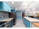 Well-lit kitchen with stainless steel appliances, island, and tile floor at 5220 Sw 161St Place Rd, Ocala, FL 34473