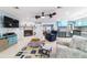 Inviting living room featuring a stone fireplace and nautical-themed decor, adjacent to the bright, blue kitchen at 5220 Sw 161St Place Rd, Ocala, FL 34473