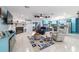 Bright, open-concept living room with tile floors, a stone fireplace, and a view of the updated kitchen at 5220 Sw 161St Place Rd, Ocala, FL 34473