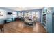 Inviting living room with wood floors, blue walls, and a comfortable seating area at 5220 Sw 161St Place Rd, Ocala, FL 34473