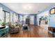Cozy living room with beautiful wood floors, comfortable seating, and an open layout at 5220 Sw 161St Place Rd, Ocala, FL 34473