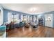 Bright living room with hardwood floors, comfortable seating, and large windows at 5220 Sw 161St Place Rd, Ocala, FL 34473