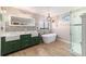 Well-lit bathroom with double sink vanity, soaking tub, and glass enclosed shower at 5220 Sw 161St Place Rd, Ocala, FL 34473