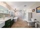 Well-lit bathroom with double sink vanity, soaking tub, and glass enclosed shower at 5220 Sw 161St Place Rd, Ocala, FL 34473