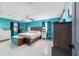 Bright main bedroom featuring tiled flooring, ceiling fan, and ensuite bathroom at 5220 Sw 161St Place Rd, Ocala, FL 34473
