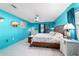 Bright main bedroom featuring tiled flooring, ceiling fan, and ensuite bathroom at 5220 Sw 161St Place Rd, Ocala, FL 34473