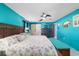 Bright main bedroom featuring tiled flooring, ceiling fan, and ensuite bathroom at 5220 Sw 161St Place Rd, Ocala, FL 34473