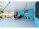 Inviting covered patio with stylish blue walls and an entertainment area with string lights at 5220 Sw 161St Place Rd, Ocala, FL 34473