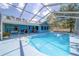 Backyard pool with screened-in enclosure offering a private and comfortable outdoor space at 5220 Sw 161St Place Rd, Ocala, FL 34473